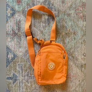 Kipling Klynn Sling Backpack in orange nylon